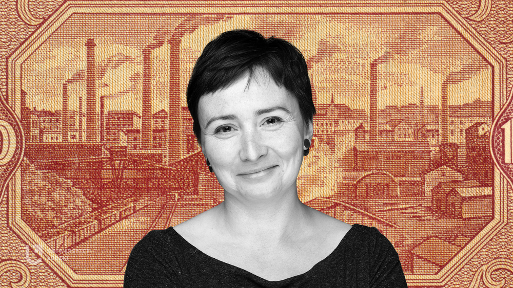 Dr Agata Zysiak against the background of the panorama of 19th-century Lodz printed on an orange textile material