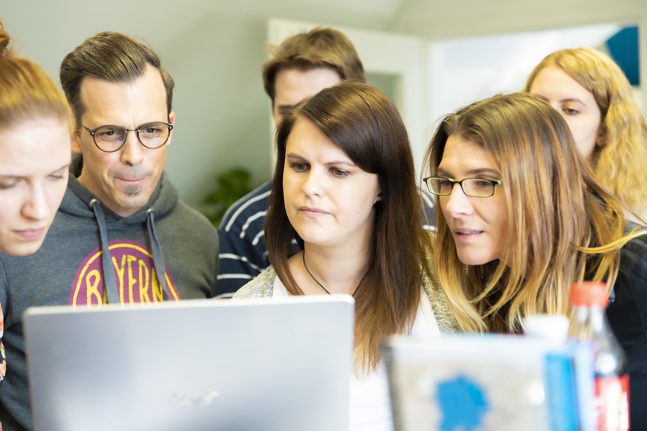 a decorative element: a group of young people looking at a laptop screen