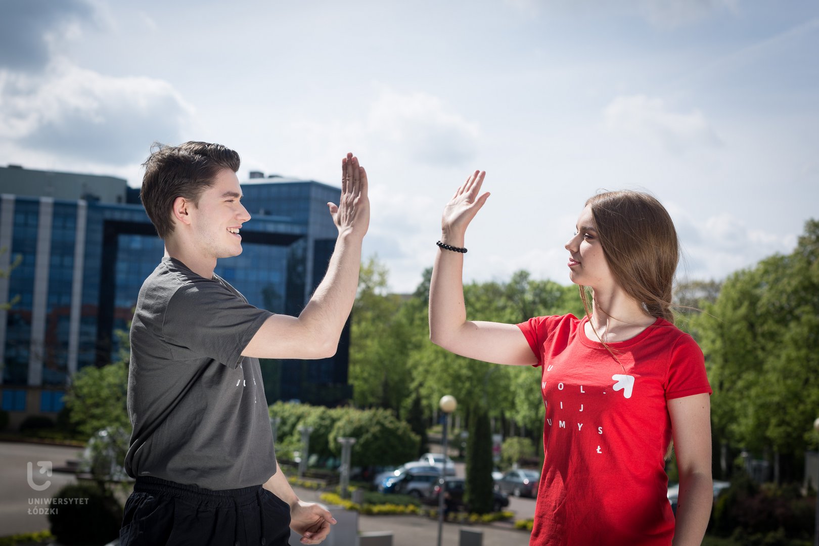 Two University of Lodz students high fiving each other.