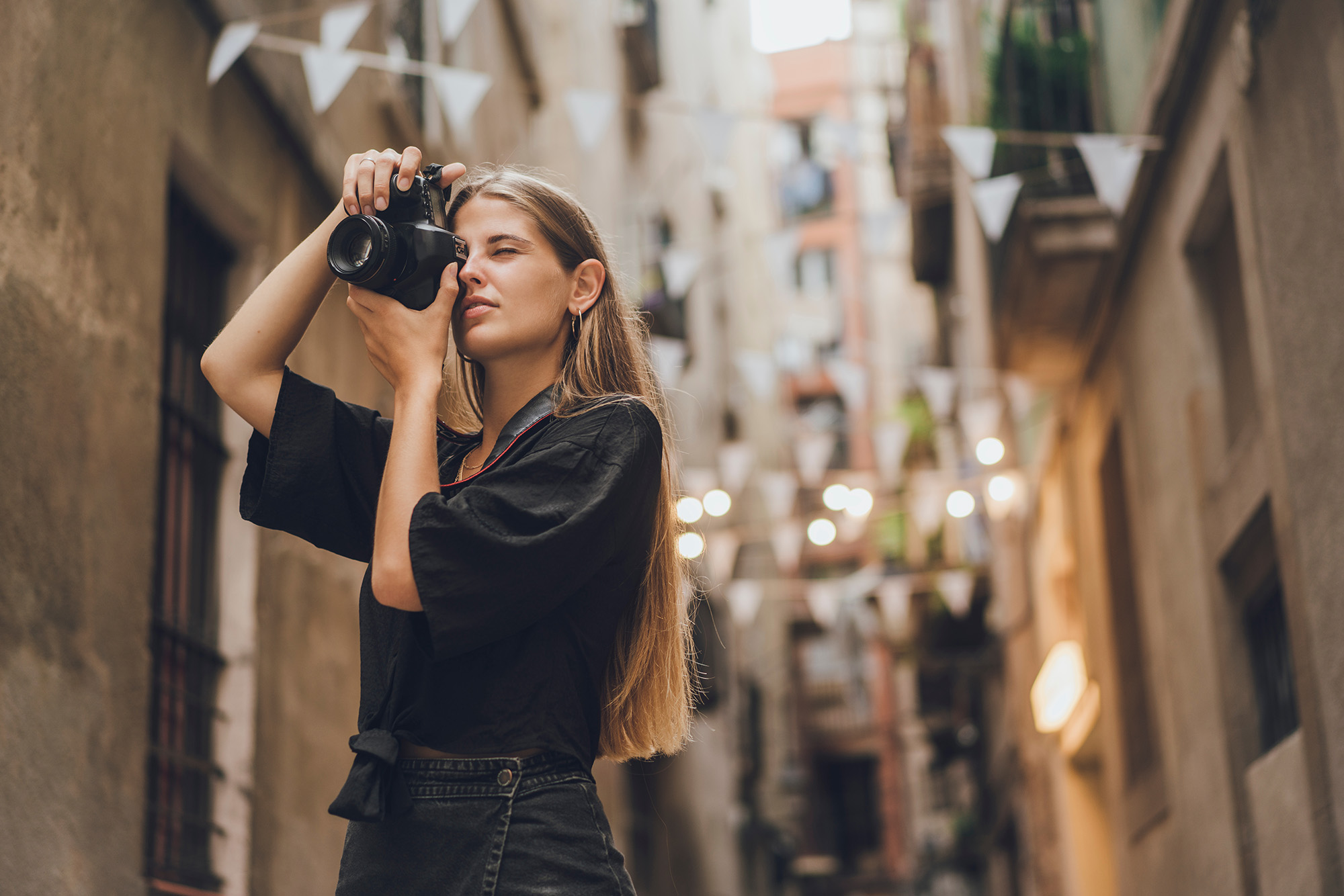 A decorative element: a young woman taking photos in the city