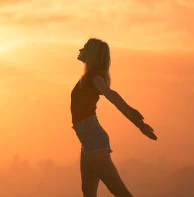 a happy man on the background of the setting sun