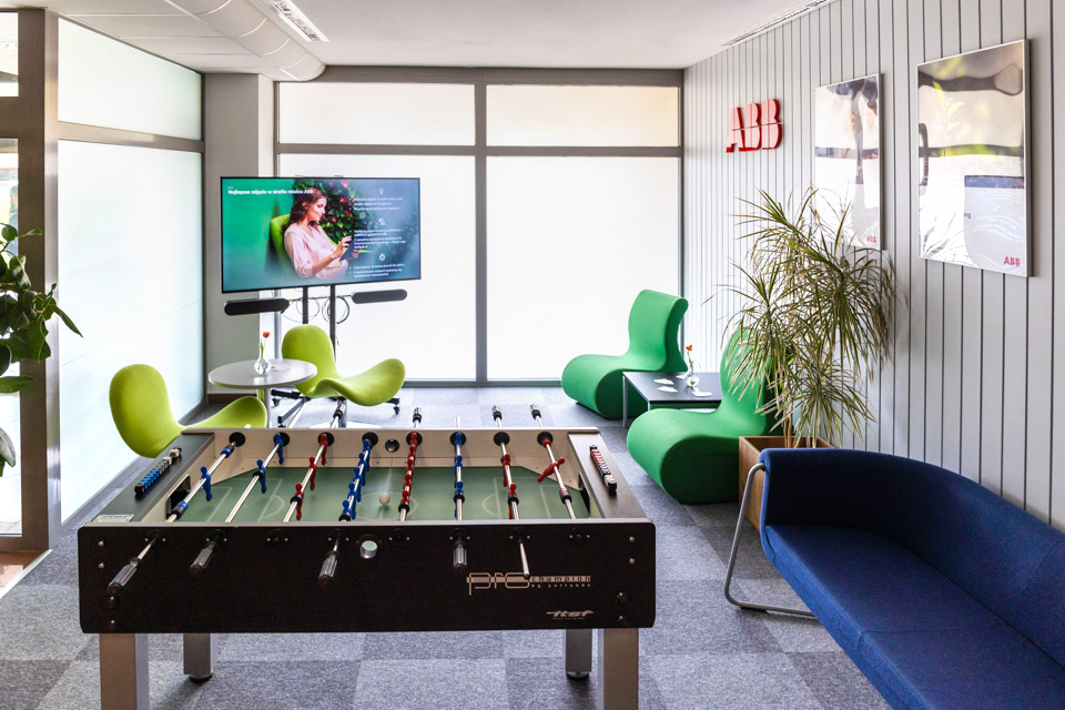 ABB relaxation zone, in the photo you can see: table football, on the right: a blue sofa, two green armchairs, a window and a TV set with a slide