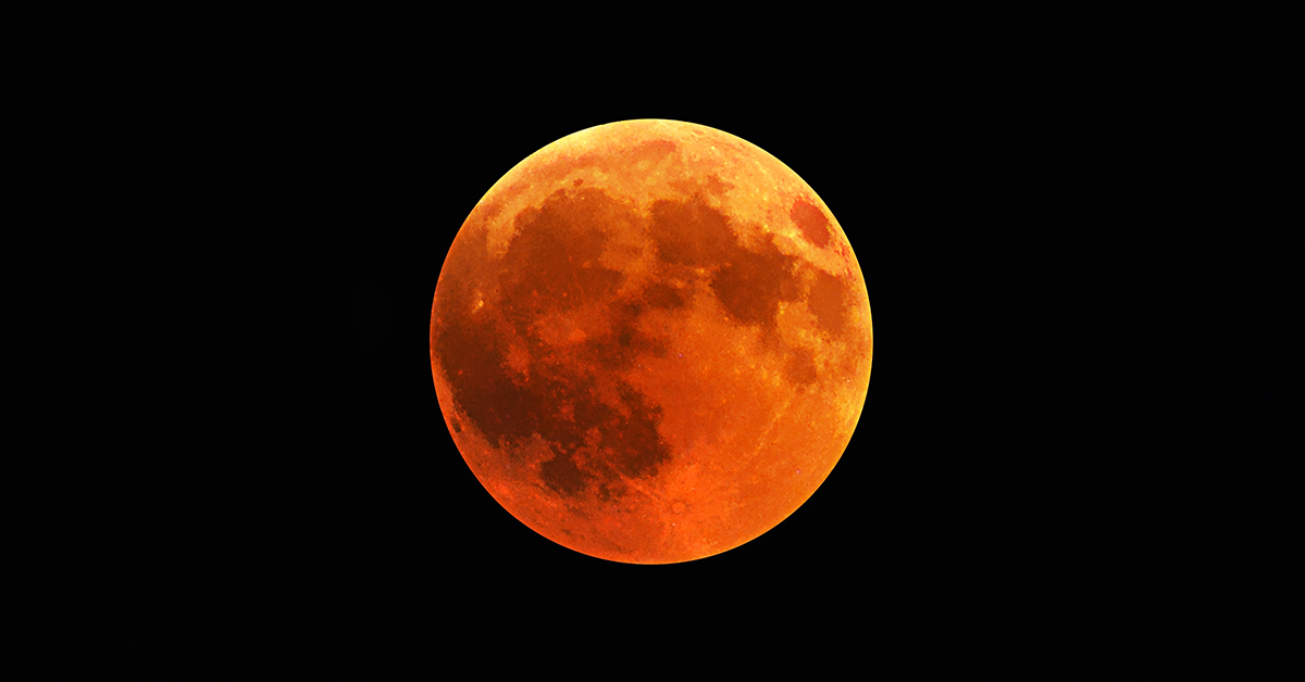 orange round moon on a black background