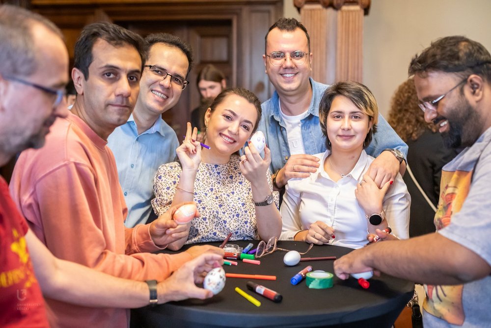 People from different countries decorating Easter eggs at one table