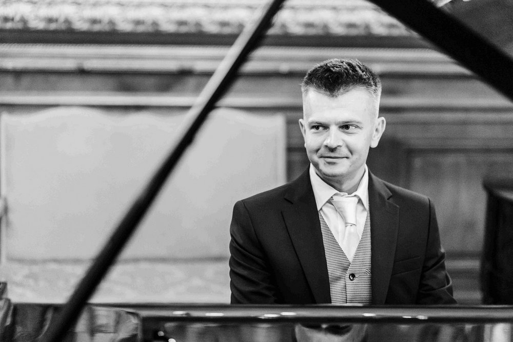 A portrait photo of Paweł Cłapiński