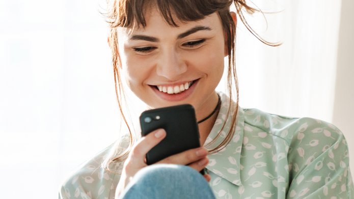 Uśmiechnięta dziewczyna z telefonem