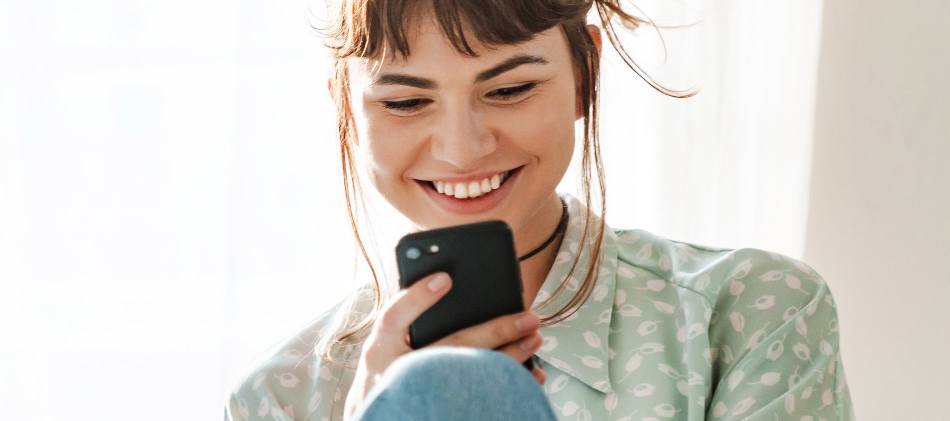 Uśmiechnięta dziewczyna z telefonem