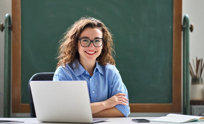 a smiling student with a laptop