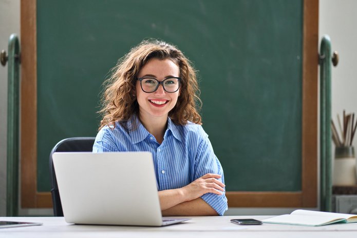 a smiling student with a laptop
