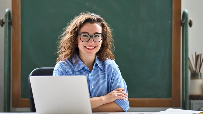 a smiling student with a laptop
