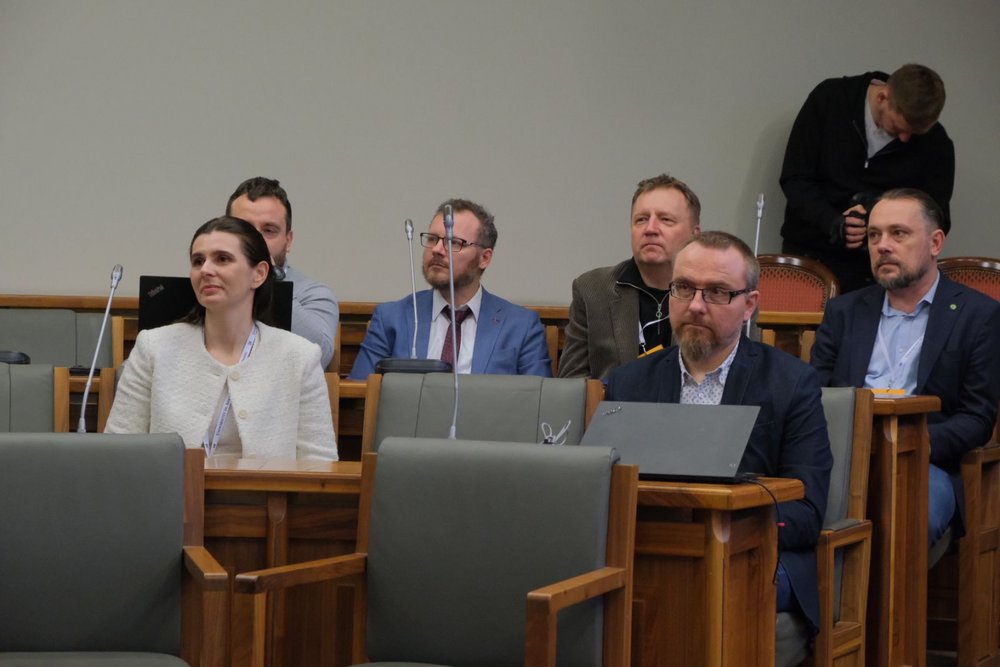 a decorative element: several people sitting in the university hall