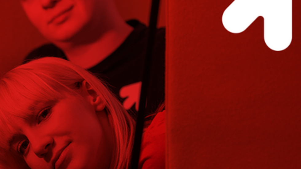 Two students, a boy and a girl, on a red background 