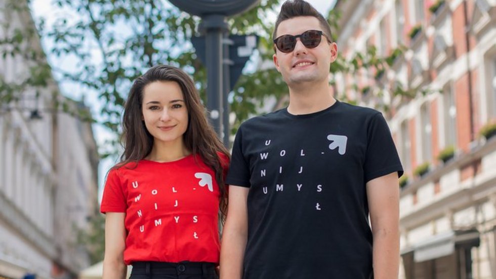 Two students of the University of Lodz (a girl and a boy) standing on Piotrkowska Street in Lodz