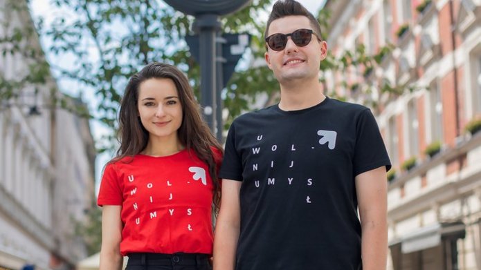 Two students of the University of Lodz (a girl and a boy) standing on Piotrkowska Street in Lodz