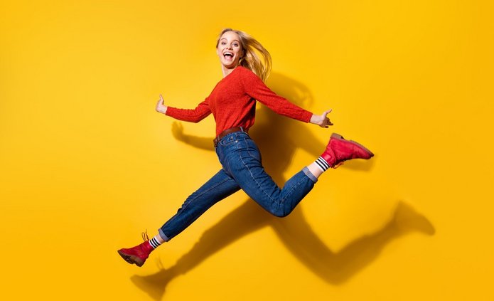 [Translate to English:] Uśmiechnięta studentka na żółtym tle