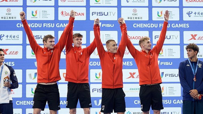 the winning relay team is presenting gold medals