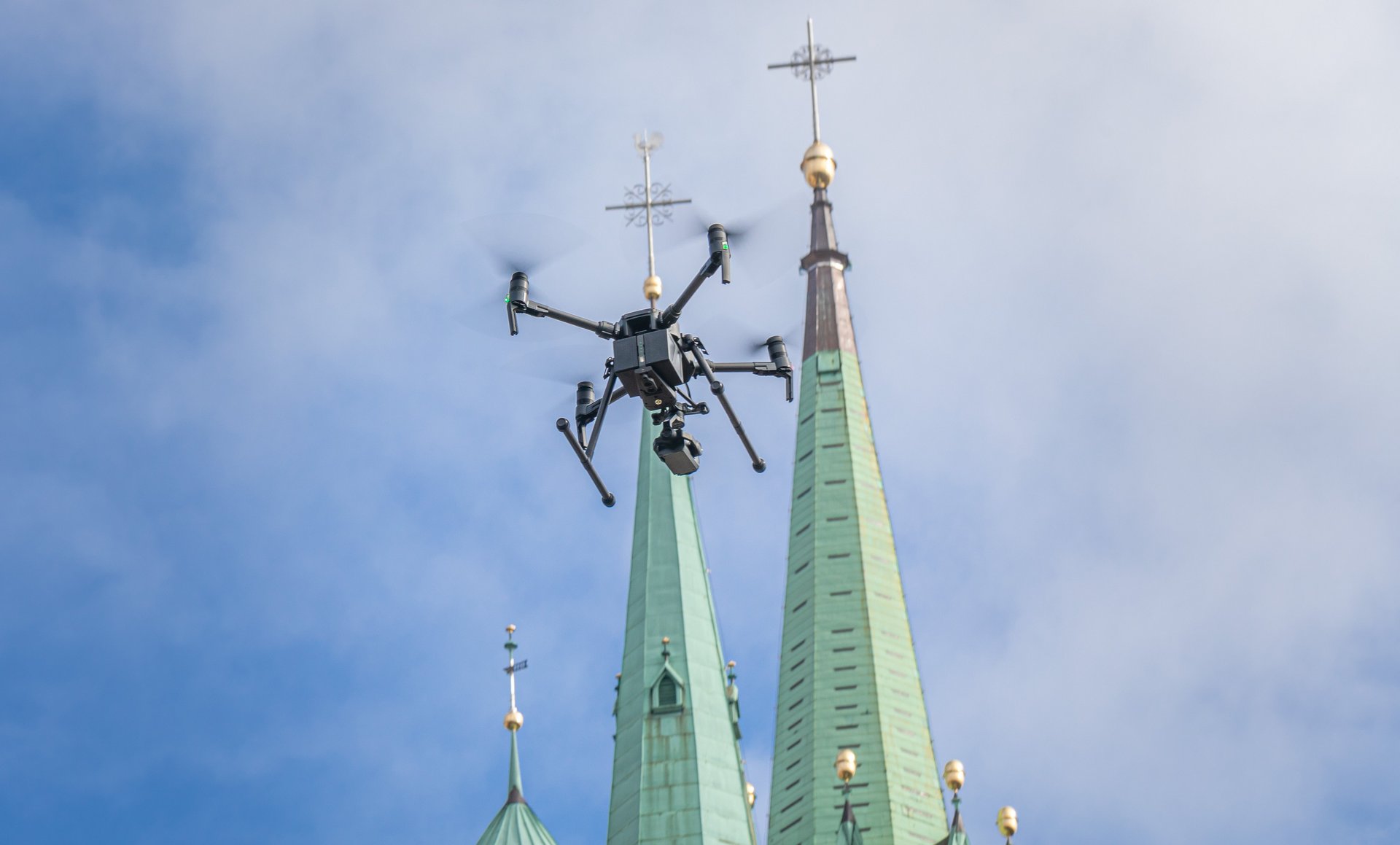 a police drone in flight over a cathedral