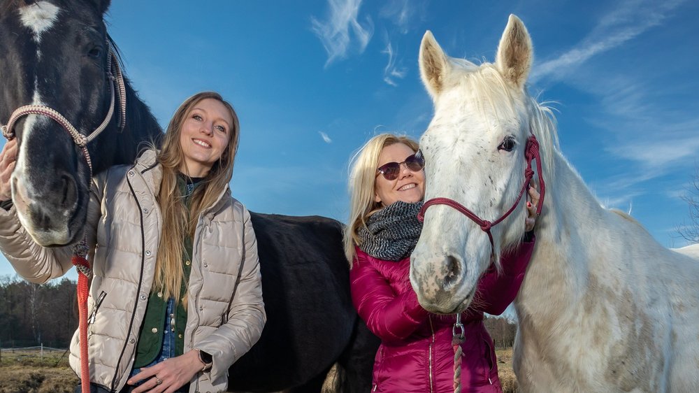 a photo of Kinga Rucka and Monika Talarowska posing with two horses