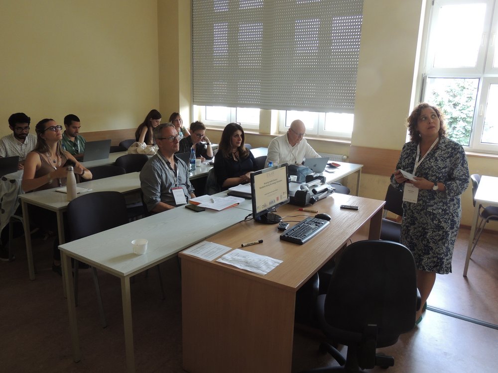The conference participants in a lecture hall during a reading 