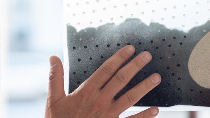 hand touching art work on glass