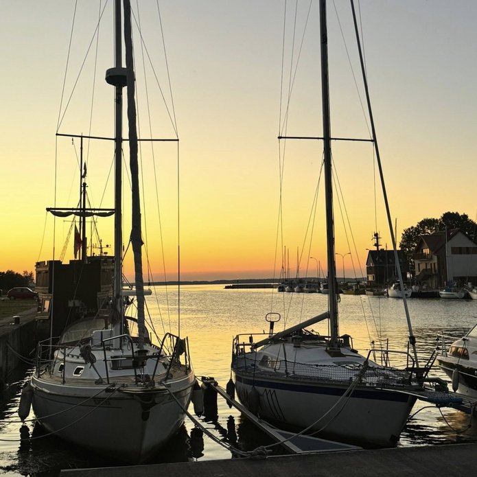 a photo - yachts in the harbour at sunset