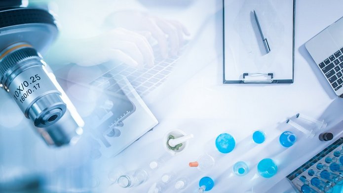 a decorative element: a microscope and a laptop
