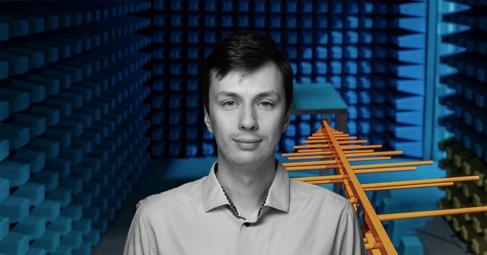 mgr inż. Maciej Ślot against the background of an aerial and a soundproof room