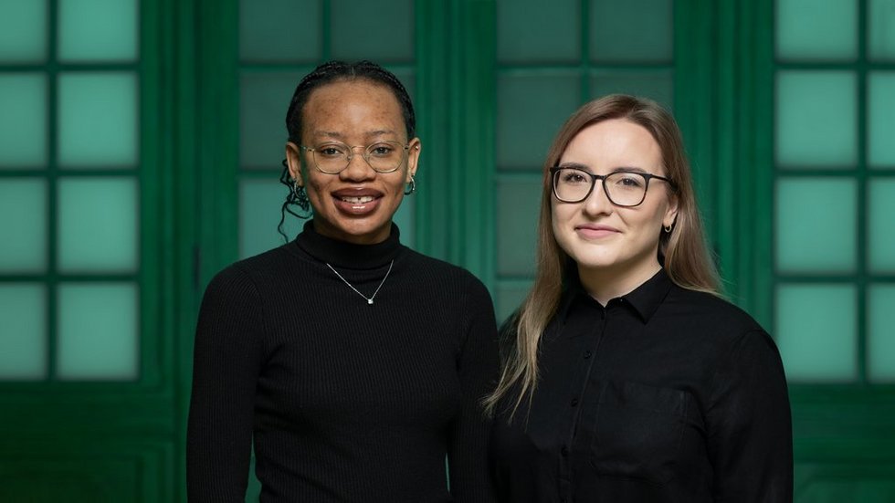 The two UNIC Ambassadors dressed in black standing next to each other