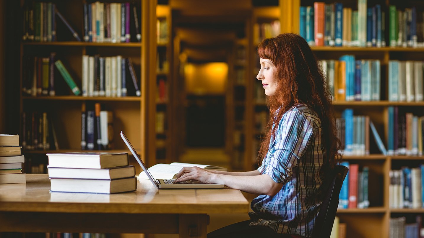 a decorative element: a woman sitting in front of a laptop