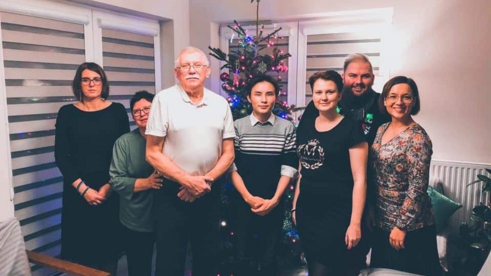 a group photo of a family taking part in the campaign with their international guests