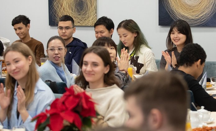 A dozen people sitting at the tables