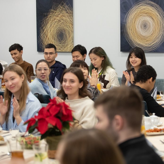 A dozen people sitting at the tables