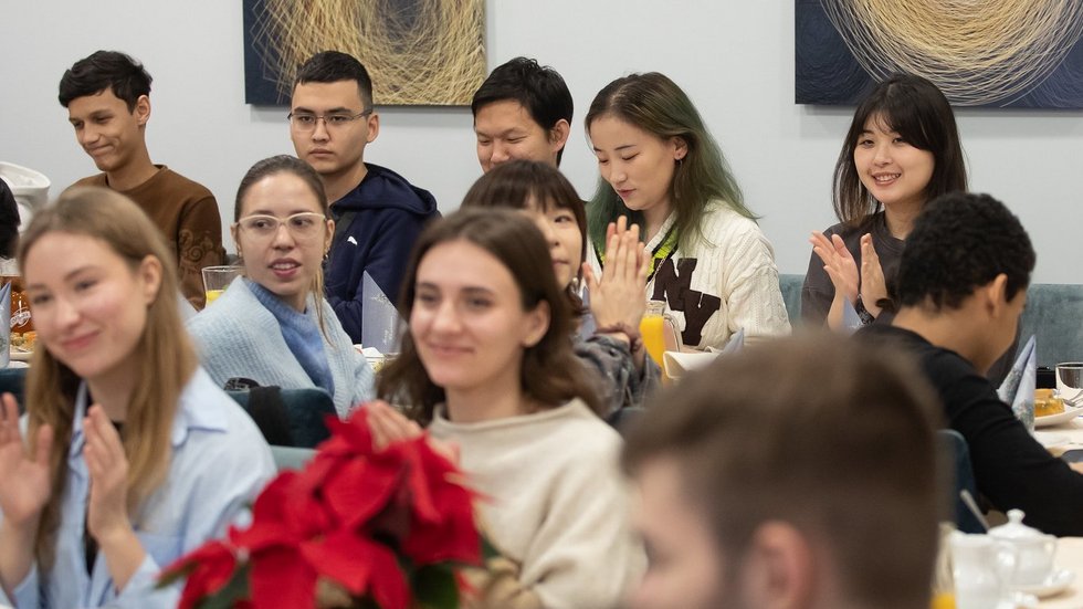 A dozen people sitting at the tables