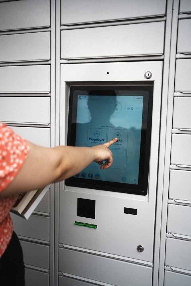 photo of a person using the book vending machine