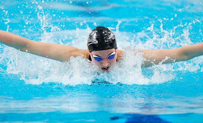A swimmer in a black swimming cap in the pool