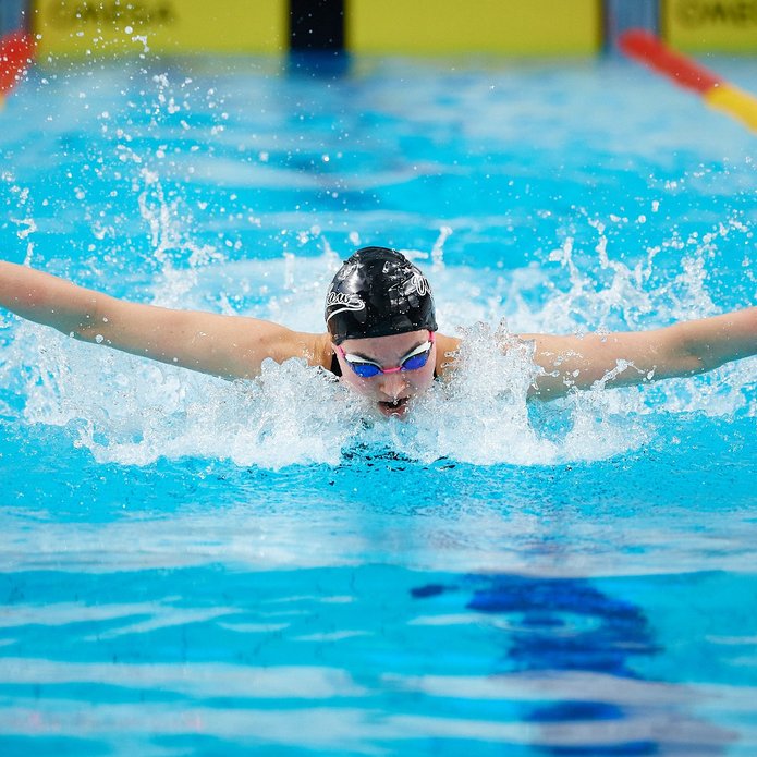 A swimmer in a black swimming cap in the pool