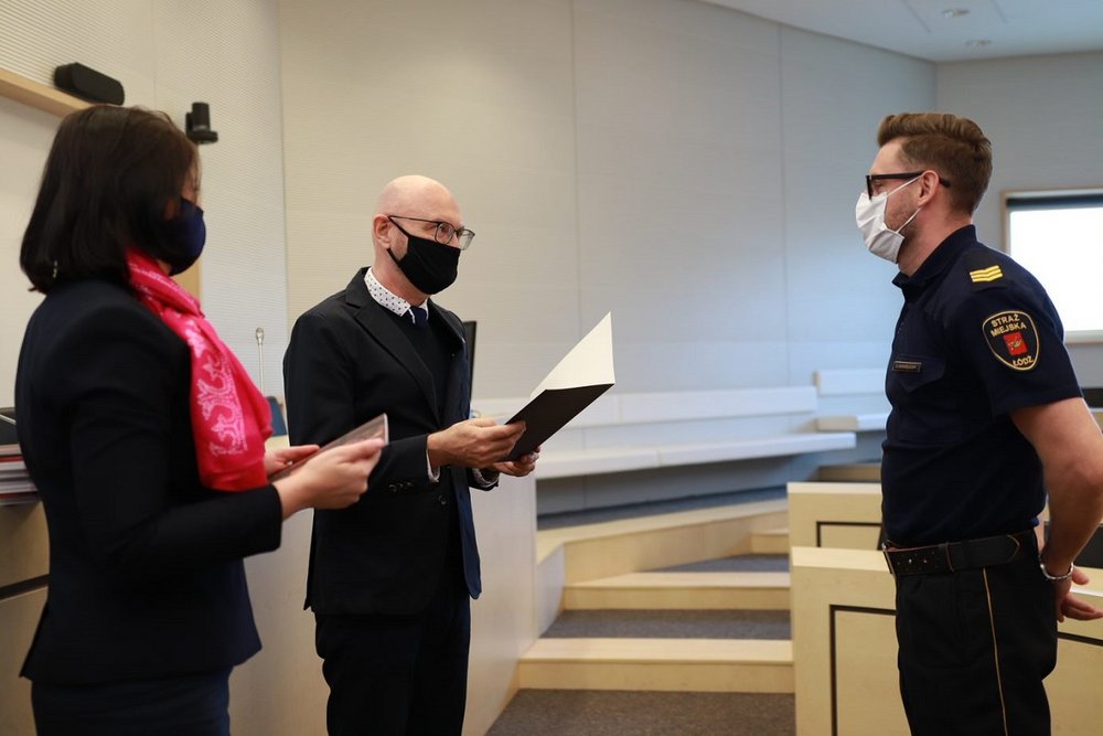 Collecting the diploma by a male city guard officer.