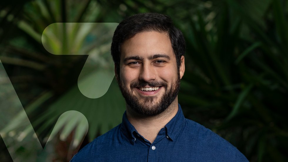 smiling Dr Naziris next to a graphic resembling the letter V