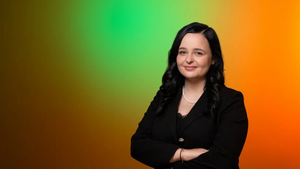 A UniLodz student standing confidently with her arms crossed.