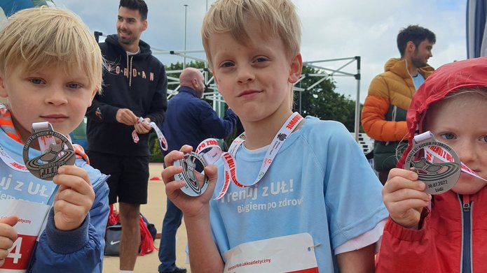 Three children with medals during an athletics picnic