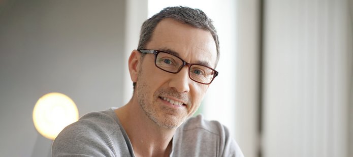 a portrait of a middle-aged man wearing glasses