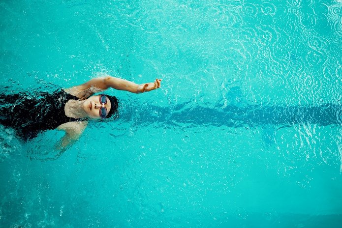 A photo of a person swimming in a swimming pool