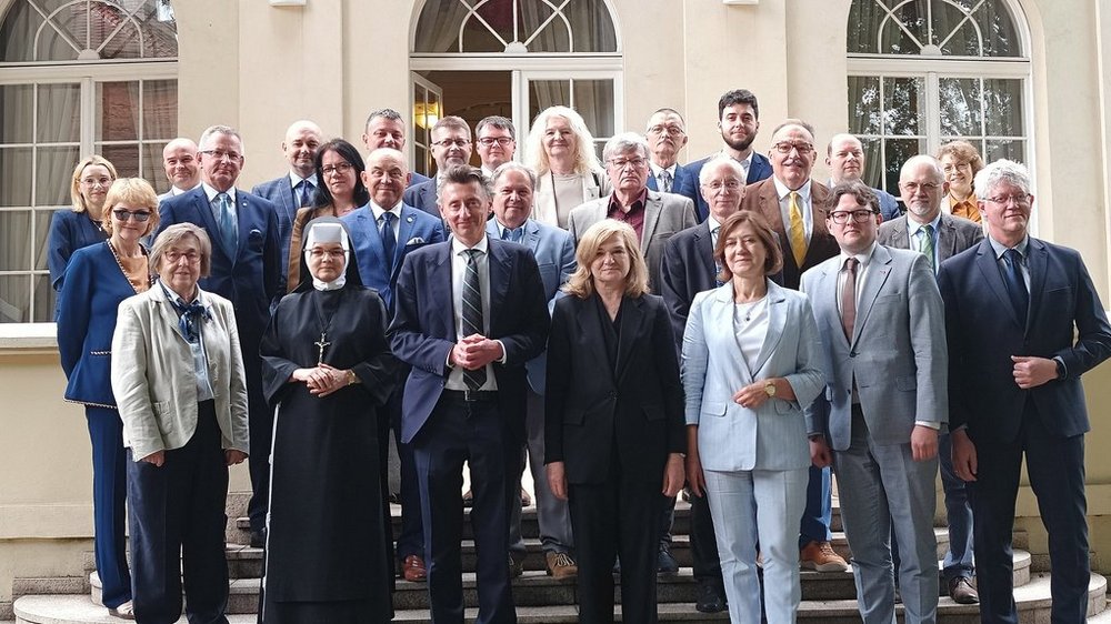 zdjęcie zbiorowe uczestników posiedzenia przed Pałacem Biedermanna