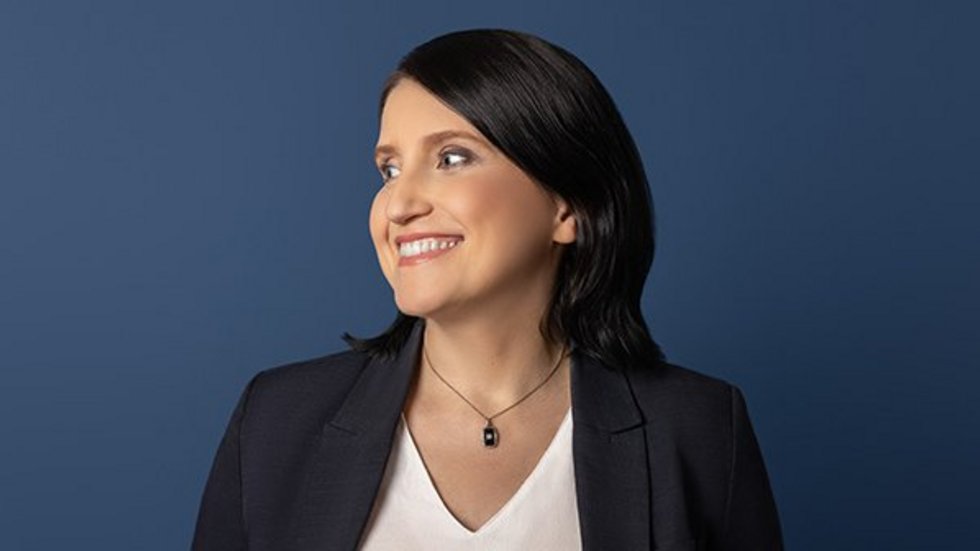 A woman in a white shirt and black jacket