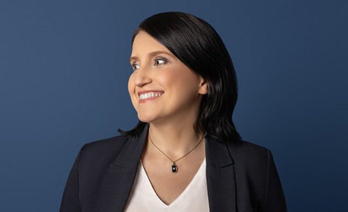 A woman in a white shirt and black jacket