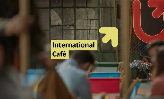 A photo showing a populated area with the University of Lodz logo and the International Café logo