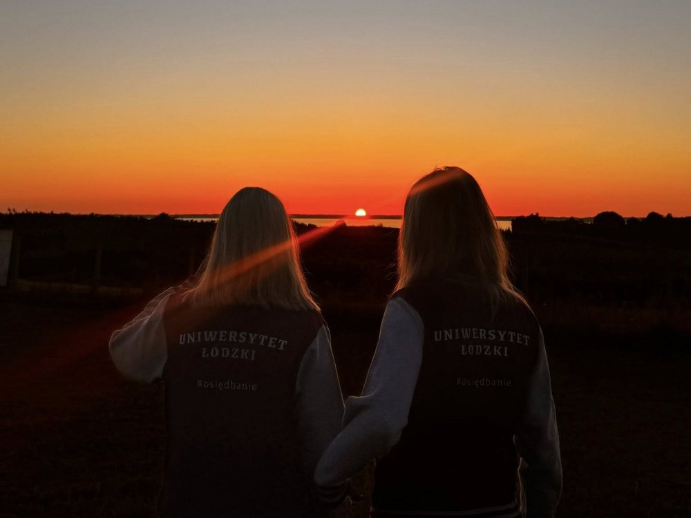 Zdjęcie-dwie studentki na tle zachodzącego słońca