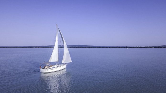 a decorative element: a photo of a sailboat on a lake