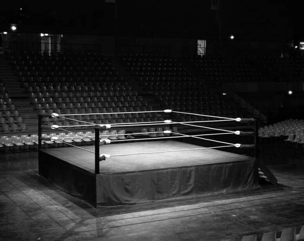 a black and white photo of the boxing ring