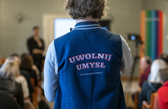 a person wearing a jacket with the "Free your Mind" slogan